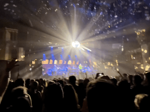 The disco ball spins the crowd